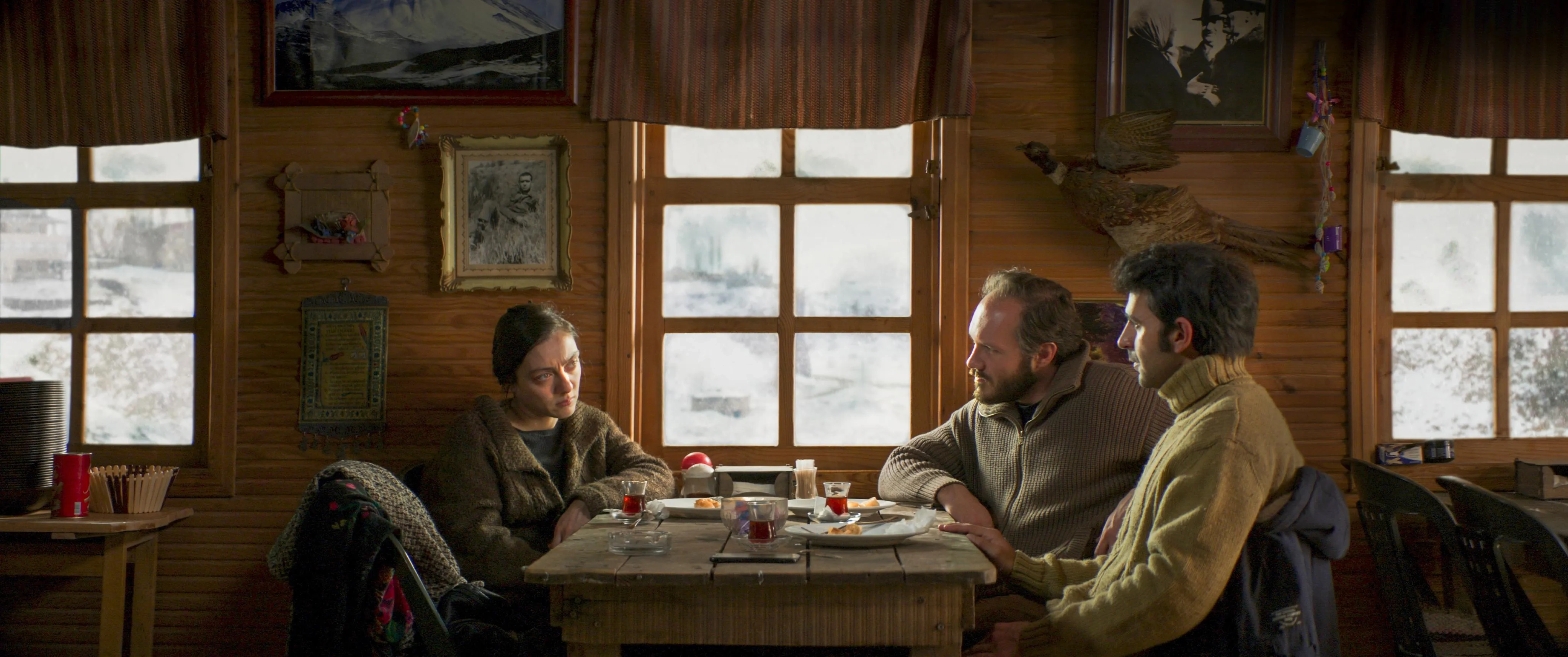 Deniz Celiloglu, Merve Dizdar, and Musab Ekici in About Dry Grasses (2023)