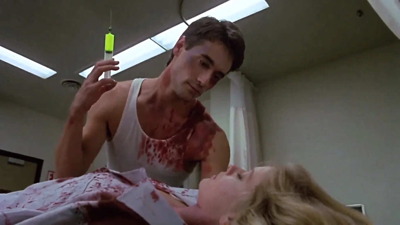 Bruce Abbott and Barbara Crampton in Re-Animator (1985)